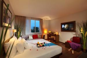 Habitación de hotel con cama grande y TV en Silverland Sakyo Hotel, en Ho Chi Minh