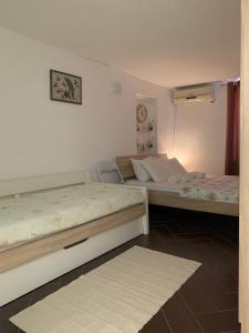 a room with two beds in a room with at Family Stone house with magical Sea View in Kaluđerac