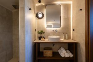 a bathroom with a sink and a mirror at Marni Village in Hersonissos