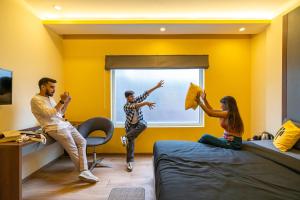 a group of people in a room with yellow walls at The Hosteller Bangalore, Brigade Road in Bangalore