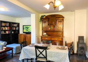 a living room with a table and a stove at Apartamenty Zacisze 1 in Poddąbie