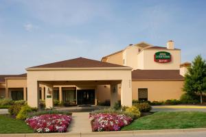 a hotel with flowers in front of a building at Courtyard by Marriott Indianapolis Airport in Indianapolis