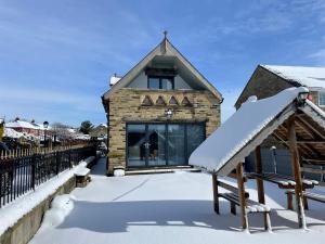 a building covered in snow with a slide at St George’s Lodge in Halifax