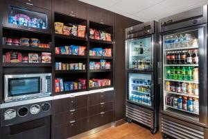 a kitchen with a refrigerator and a microwave at Courtyard Harlingen in Harlingen