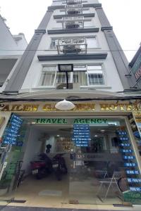 a building with a travel agency sign in front of it at Ailen Hotel in Ho Chi Minh City