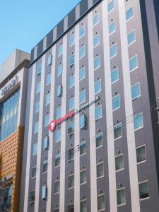 a building with a sign on the side of it at Travelodge Kyoto Shijo Kawaramachi in Kyoto