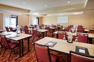 a conference room with tables and chairs and a whiteboard at Courtyard Foothill Ranch Irvine East/Lake Forest in Foothill Ranch
