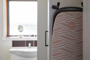 a bathroom with a toilet and a sink and a window at Mountain Explorer - perfect base for exploring in Deloraine +13 photos