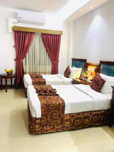 Gulta vai gultas numurā naktsmītnē Hotel West Valley Dhaka