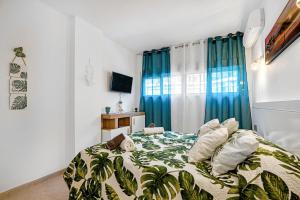 a bedroom with a bed with a blue curtain at Selene in Calpe