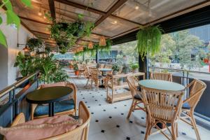 a restaurant with tables and chairs and plants at Novotel Sydney Darling Square in Sydney