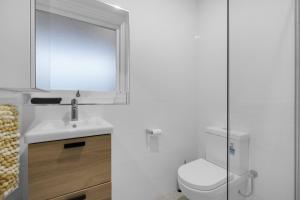 a bathroom with a toilet and a sink and a shower at Perfect Cosy Beachside Escape in Grange