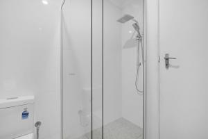 a shower in a bathroom with a glass door at Perfect Cosy Beachside Escape in Grange