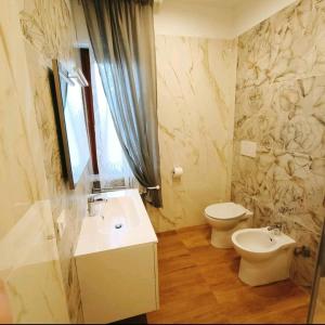 a bathroom with a sink and a toilet at Donata dal mare in Francavilla al Mare