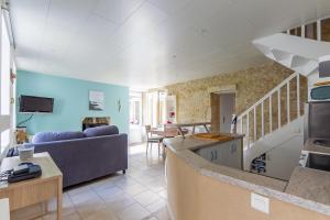 a living room with a couch and a table at La Rochambelle - Charmante maison de pêcheurs in Bernières-sur-Mer