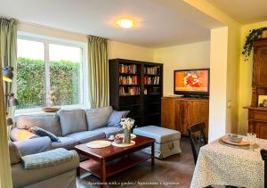 a living room with a couch and a table at Apartamenty Zacisze 1 in Poddąbie