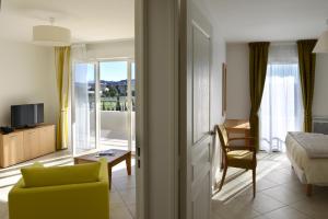 a hotel room with a bed and a room with a view at Domitys Les Côteaux de l'Esterel in Fréjus