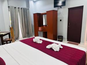 SP Tourist Hotel Jaffna客房内的一张或多张床位