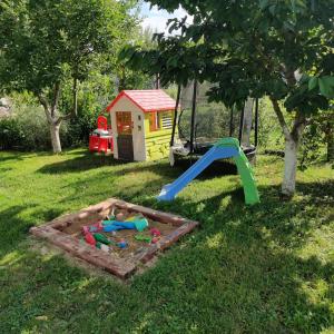 a childs play set in the grass with a playground at Nest in Spišská Nová Ves