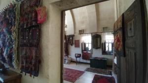 an open doorway to a room with rugs on the walls at CAPPADOCİA DAİLY WELLNESS MEDİTATİON CENTER in Ürgüp