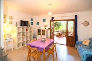 a living room with a purple table and a couch at CASA PAU in Porto Ottiolu