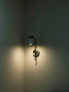 a light on a wall in a room at Astina Hotel in Astana