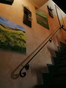 a set of stairs with paintings on the wall at La Marchesina in Ronciglione