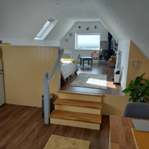 una camera con letto e scala di Tobar Na Si Apartments a Letterkenny