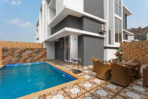 a swimming pool in front of a building at Denver Villa in Lonavala