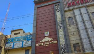 un edificio rojo con un cartel en el costado en HOTEL LIME WOOD en Ludhiana