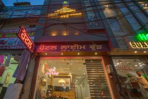a store with neon signs on the front of it at HOTEL LIME WOOD in Ludhiana