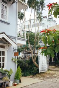 a white house with a white fence and plants at Art Garden Dalat in Da Lat