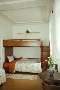 a bedroom with a bed and a table at Art Garden Dalat in Da Lat