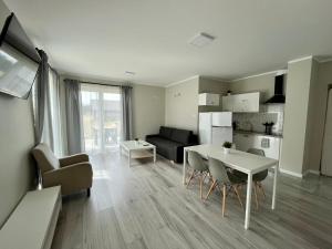 a kitchen and living room with a table and chairs at Gościniec Wigry 2 in Walne