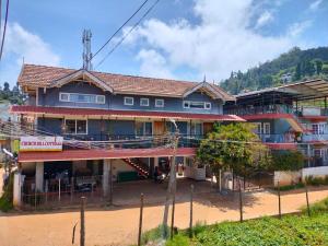 a house in a village on a dirt road at Church Hill Cottage in Ooty