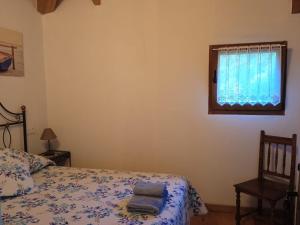 Postel nebo postele na pokoji v ubytování Casa rural en Asturias a orillas del río Narcea puerta de Somiedo