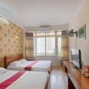 Postel nebo postele na pokoji v ubytování Khách sạn Ngân hàng - Bank Hotel