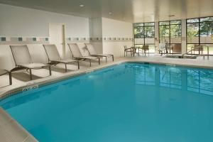 a large swimming pool with chairs and a table at Courtyard by Marriott Waldorf in Waldorf