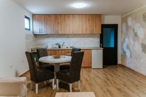 a kitchen with a table and chairs in a room at B&B LUX Pavlovci in Pavlovci
