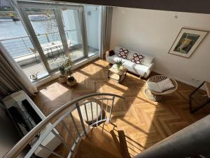 an overhead view of a living room with a staircase at Bremen Weser Best View Apartment in Bremen