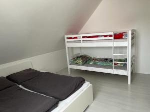 a white bedroom with a bed and a white shelf at Rekreační Domek Litenčice na Jižní Moravě in LitenÄice +91 photos