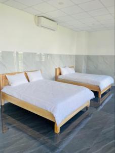 Postel nebo postele na pokoji v ubytování Ánh Mai Hotel