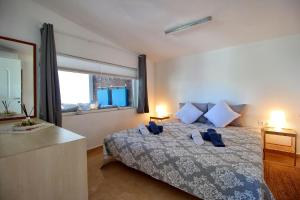 a bedroom with a bed and a large window at Casa Mary di Mare in Epanomi