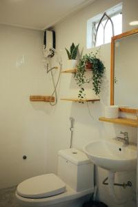 a bathroom with a toilet and a sink at Art Garden Dalat in Da Lat
