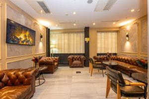 a waiting room with leather couches and tables at Premist Hotels Taksim in Istanbul