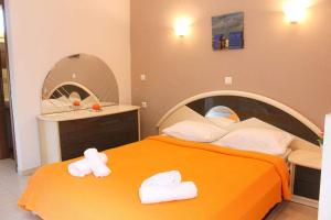 a bedroom with a bed with two towels on it at GOLDEN SUN STUDIOS in Kallithea Halkidikis
