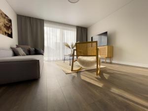 a living room with a couch and a chair at Gailė Palanga in Palanga