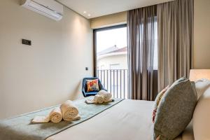 Blissful Suites Porto by gaiarooms客房内的一张或多张床位