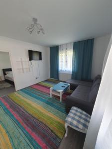 a living room with a couch and a table at meda's apartament in Floreşti