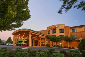 a hotel building with a truck parked in a parking lot at Courtyard Medford Airport in Medford